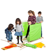 Children building a large cube structure made from pieces out of the Trigonos maxi green construction set.