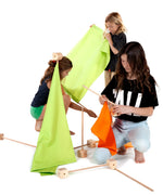 Children assembling wooden poles into blocks and coloured cotton sheets from the Trigonos maxi green construction set.