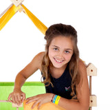 Child inside a tent structure made from the Trigonos maxi green wooden construction set