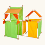 Trigonos maxi green construction set showing a den made from wooden poles, blocks and coloured cotton sheets 