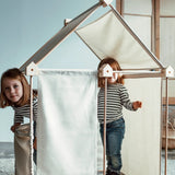 Children inside a tent made from the Trigonos kernel organic set showing white cotton sheets used on the sides and roof