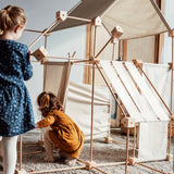 Children building multiple dens using the Trigonos family wooden construction set 