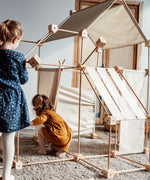 Children building multiple dens using the Trigonos family wooden construction set 