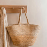 Turtle Bags natural block colour jute basket hanging on a wooden coat hanger