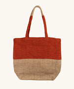 The Turtle Bags hand woven fair trade jute tote bag, in an orange paprika colour block design