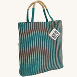 The Turtle Bags hand woven jute tote bag, in a teal stripe design with medium length handles