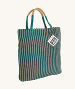 The Turtle Bags hand woven jute tote bag, in a teal stripe design with medium length handles