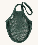 The Turtle Bags organic and fair trade cotton string bag for grocery shopping - in a bottle green colour