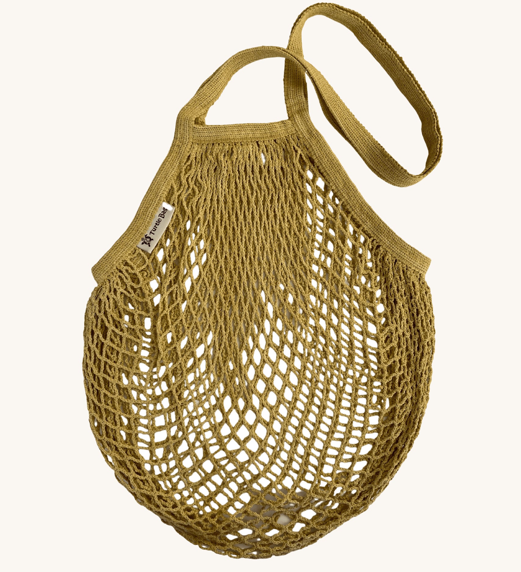 The Turtle Bags organic and fair trade cotton string bag for grocery shopping - in a vegetable dyed botanic ochre yellow colour