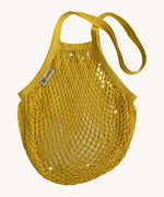The Turtle Bags organic and fair trade cotton string bag for grocery shopping - in a sunflower yellow colour