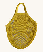 The Turtle Bags organic, fair trade cotton string grocery shopping reusable bag in sunflower yellow