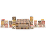 Uncle Goose eco-friendly wooden German toy blocks stacked in lines on a white background next to their cardboard box