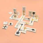 Uncle Goose kids wooden arrow chips laid out in a geometric pattern on an orange background