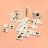 Uncle Goose kids wooden arrow chips laid out in a geometric pattern on an orange background