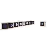 Uncle Goose eco-friendly handmade moon phase cubes lined up in order on a white background
