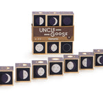 Uncle Goose handmade wooden moon cubes lined up in order of phases on a white background in front of their packaging