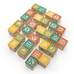Uncle Goose eco-friendly wooden Spanish language blocks laid out in a chevron pattern on a white background