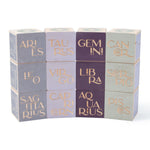 Uncle Goose zodiac sign toy blocks stacked in a curved tower on a white background