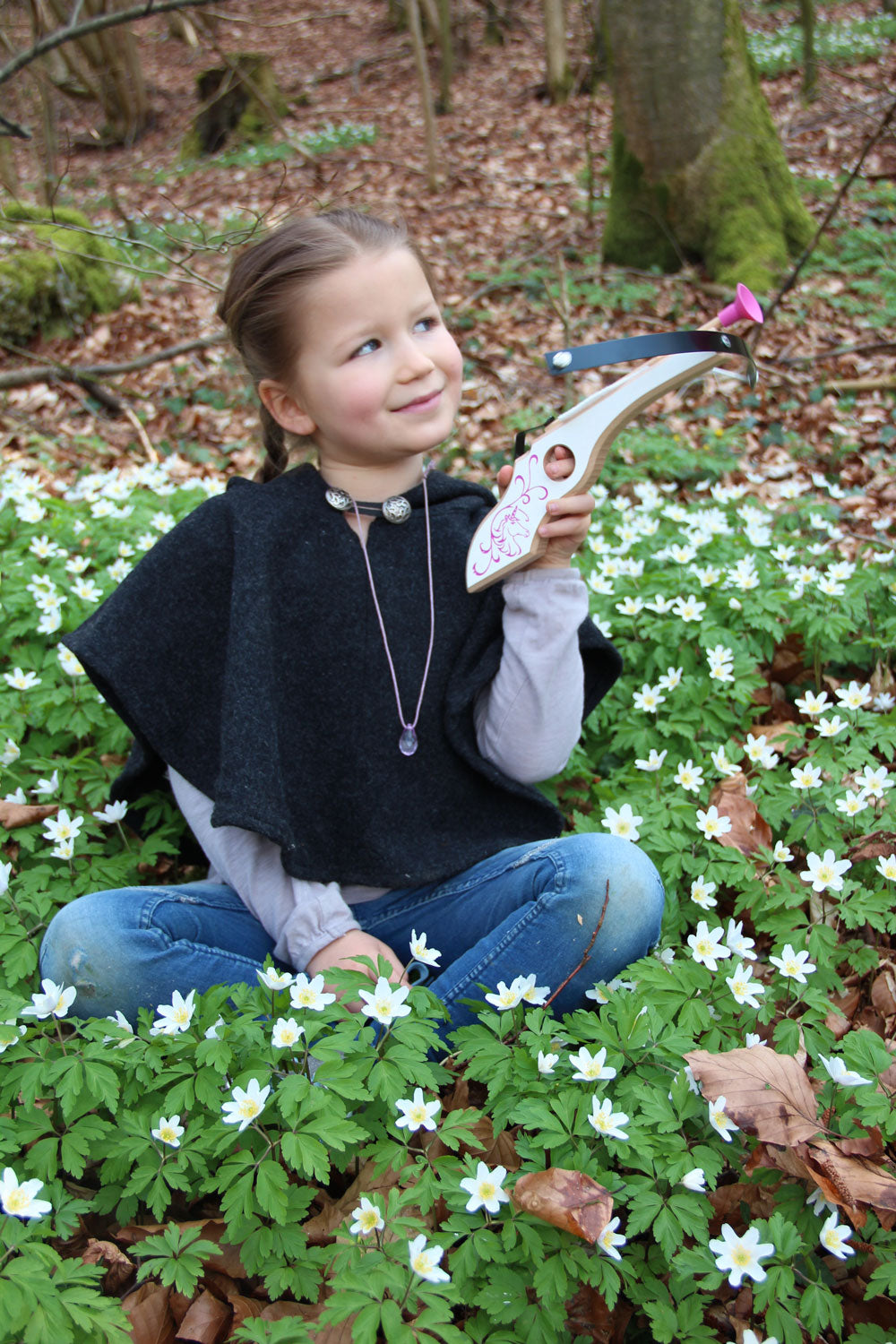 Child holding the Vah Arabella Unicorn Wooden Crossbow with Arrows