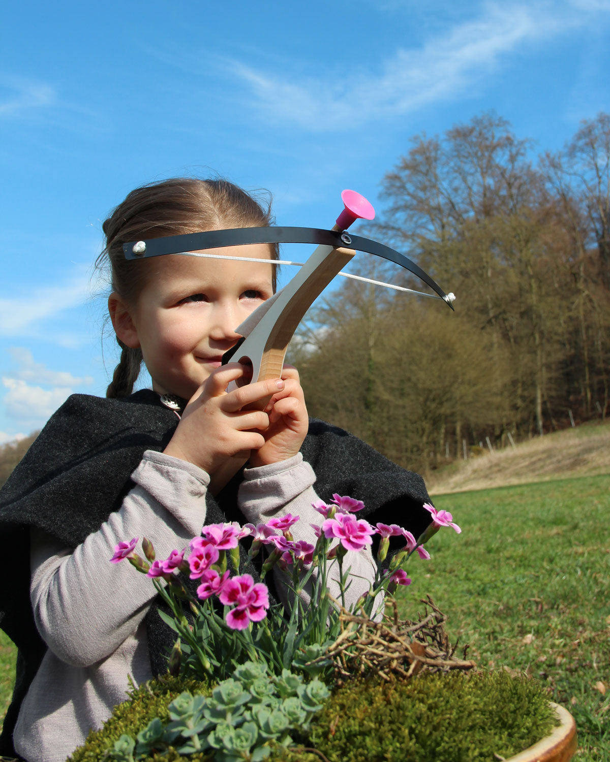 Child taking aim with the Vah Arabella Unicorn Wooden Crossbow with Arrows