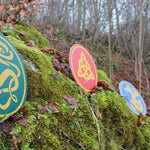 Vah Celtic Sigar Wooden Shield pictured outdoors with 2 other Celtic shields in the background