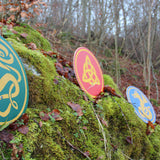 Vah Celtic Sigar Wooden Shield pictured outdoors with 2 other Celtic shields in the background
