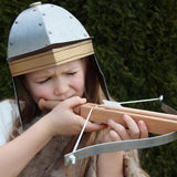 Child wearing the Vah Gallic Roman Helmet taking aim with a crossbow