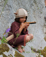 Child playing with the Vah Junior Wooden Bow toy