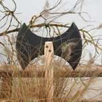 Vah Two-edged Wooden Viking Hatchet pictured outdoors placed against a fence behind reeds