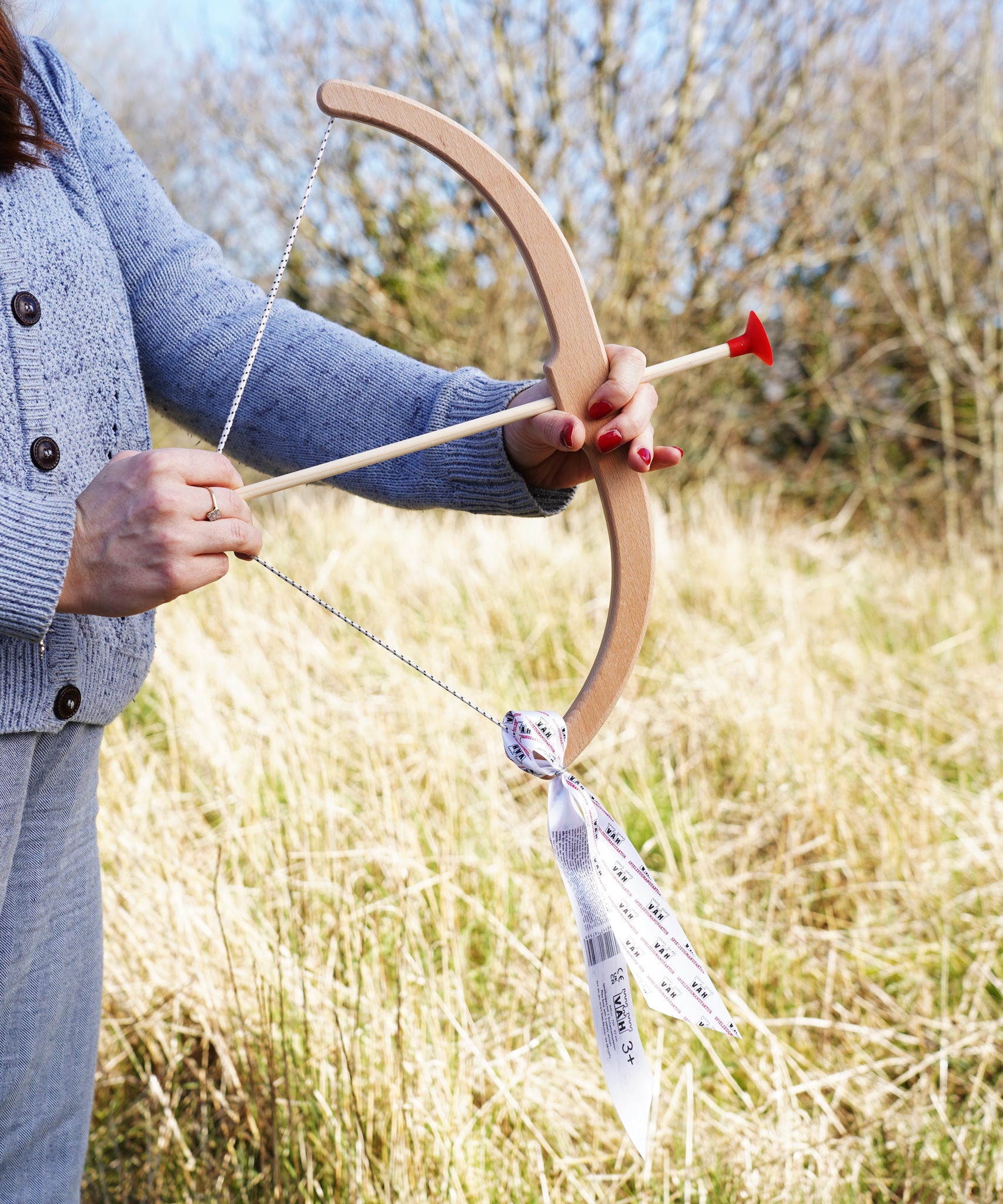 An adult getting ready to take aim with the Vah Easy Aim Bow with Safety Arrows Set.