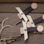 Three Vah Excalibur Wooden Sword Sets pictured on a pile of woolen felted  sheaths in a box