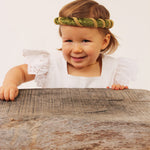 Child wearing the vah green Isabella Medieval Veil and a white dress
