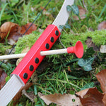 The Vah Mini Wooden Bow with Safety Arrows pictured on grass outdoors showing close up of arrow and red detail