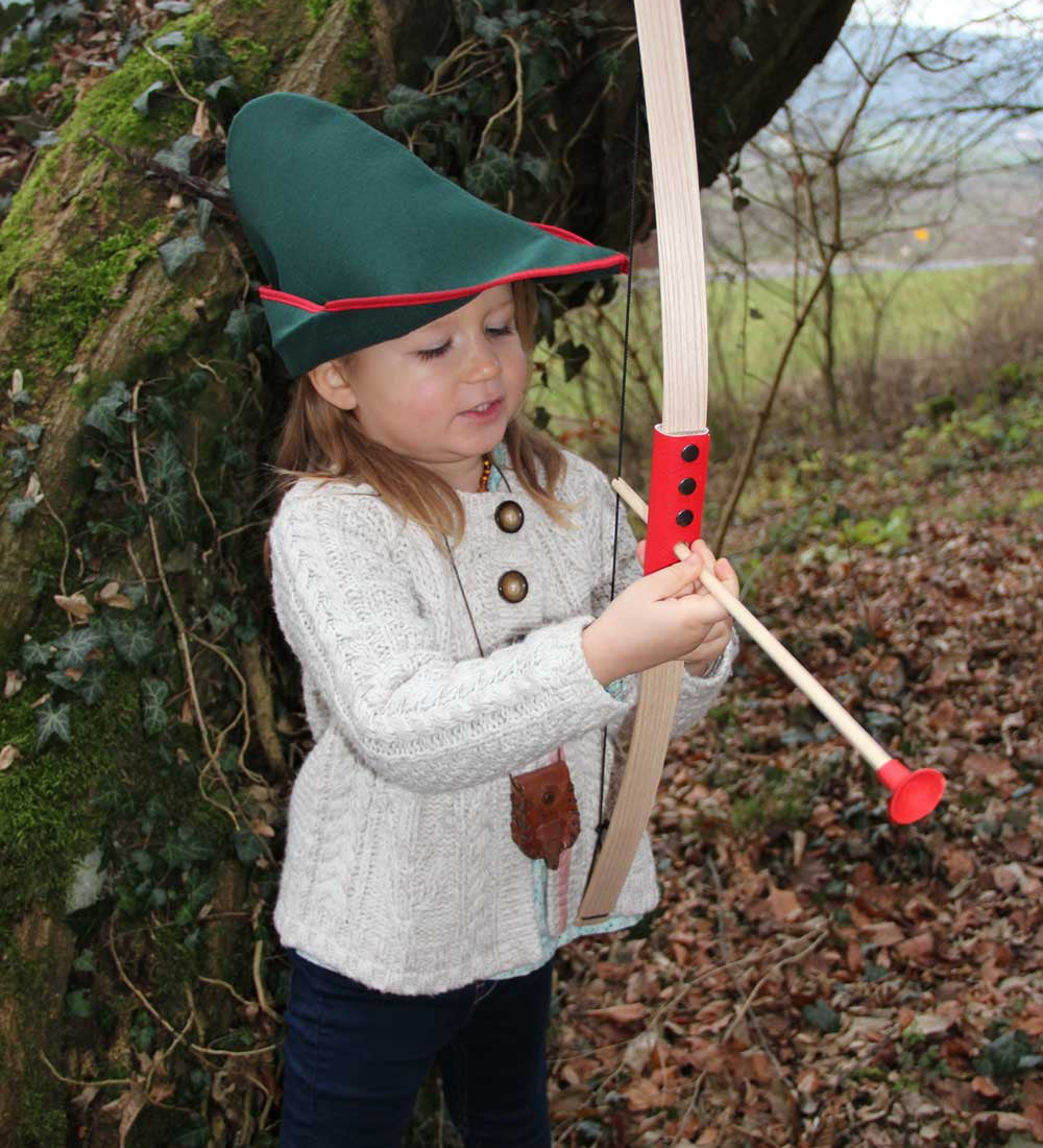 Child outdoors playing with the Vah Mini Wooden Bow with Safety Arrows