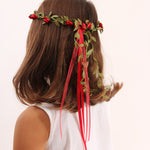 Child wearing the Vah red Flower Crown. View of back of child's head