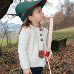 A child wearing a VAH robin hood hat playing with a bow and arrow.