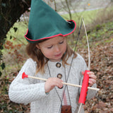 A child wearing a VAH robin hood hat playing with a bow and arrow.