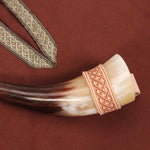 Vah Natural Drinking Horn with Belt Loop Holder - 0.1L pictured on a maroon brown material