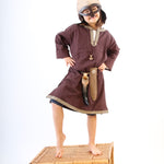 Child wearing a Vah Wiki Viking Helmet with Glasses stood on a wicker hamper
