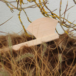 Vah wooden mini axe toy placed among branches