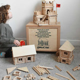 Walachia Vario Box & Fort Building Set 450 Pieces. The blocks are supplied in a large wooden storage case. There are three different builds around the wooden crate. A child in sitting besides the crate and is placing a Babipur elephant figure on the roof of a log cabin build.
This modular wooden building block system is perfect for those who enjoy a challenge. The sets are available in various sizes at Babipur. 