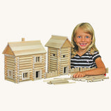 A child besides structures created using pieces from the Walachia Vario Massive Wooden Building Set containing 209 Pieces. This modular wooden building block system is perfect for those who enjoy a challenge. The sets are available in various sizes at Babipur.  