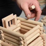 A close up of a tower being built using pieces from the Walachia Vario XL Building Set 184 Pieces. This modular wooden building block system is perfect for those who enjoy a challenge. The sets are available in various sizes at Babipur.  