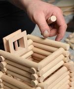 A close up of a tower being built using pieces from the Walachia Vario XL Building Set 184 Pieces. This modular wooden building block system is perfect for those who enjoy a challenge. The sets are available in various sizes at Babipur.  