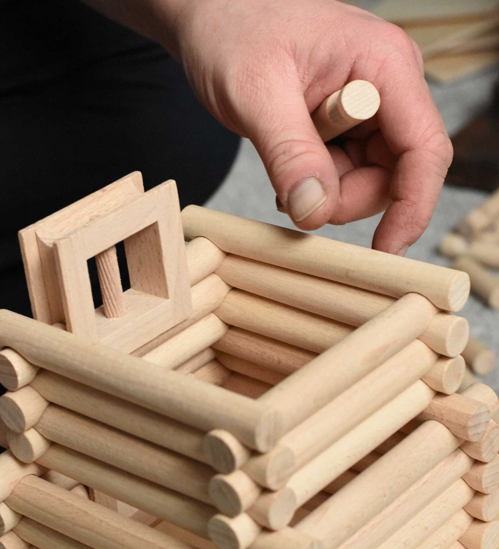 A close up of a tower being built using pieces from the Walachia Vario XL Building Set 184 Pieces. This modular wooden building block system is perfect for those who enjoy a challenge. The sets are available in various sizes at Babipur.  
