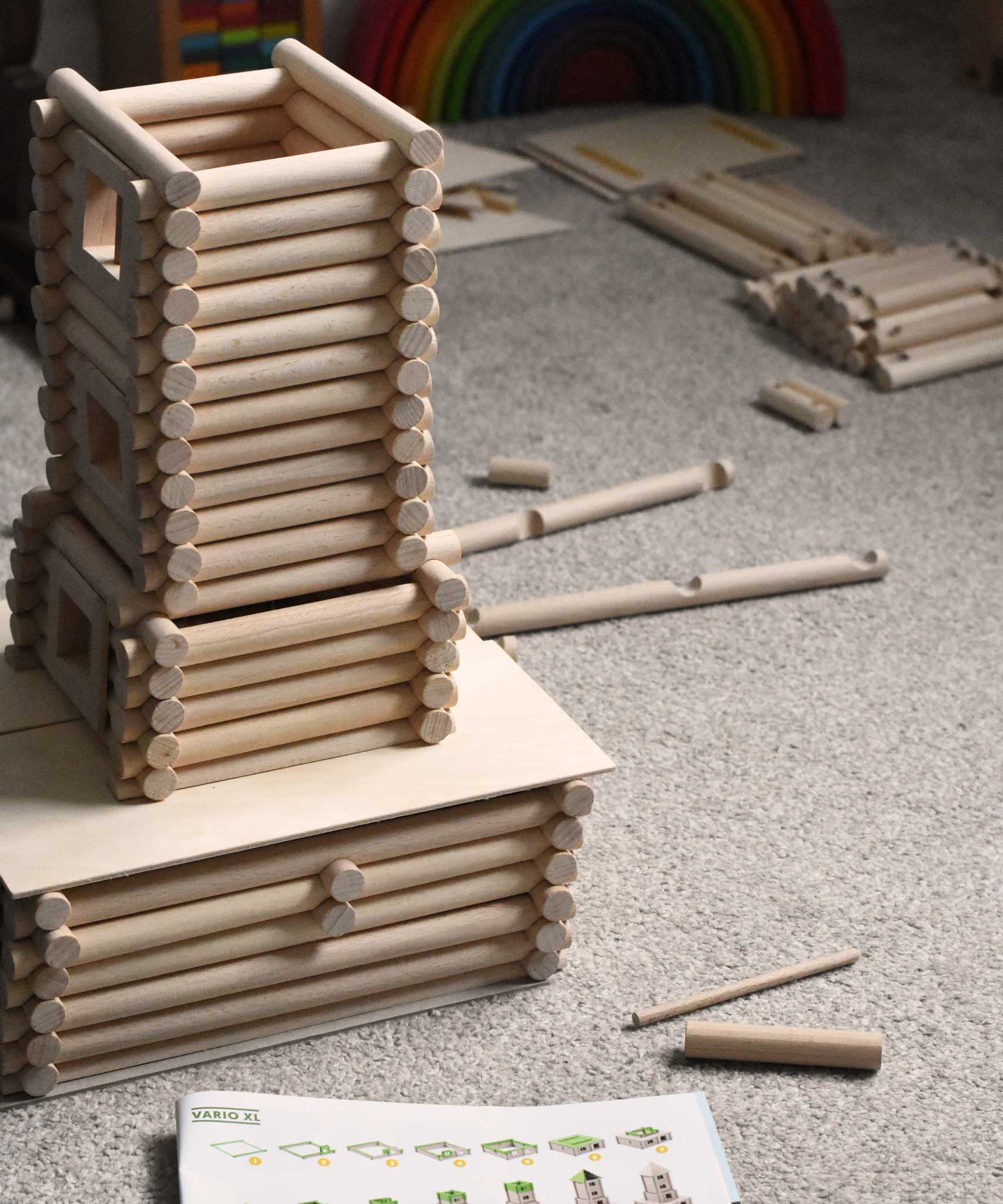 A tower part way built using pieces from the Walachia Vario XL Building Set 184 Pieces.  This modular wooden building block system is perfect for those who enjoy a challenge. The sets are available in various sizes at Babipur.  