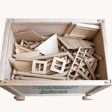 An open crate containing the Walachia Vario Box & Fort Building Set 450 Pieces. The blocks are supplied in a large wooden storage case. There are three different builds around the wooden crate. This modular wooden building block system is perfect for those who enjoy a challenge. The sets are available in various sizes at Babipur. 