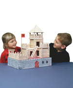 Two children looking at the fort build created using the Walachia Vario Fort Building Set 194 Pieces. This modular wooden building block system is perfect for those who enjoy a challenge. The sets are available in various sizes at Babipur. 