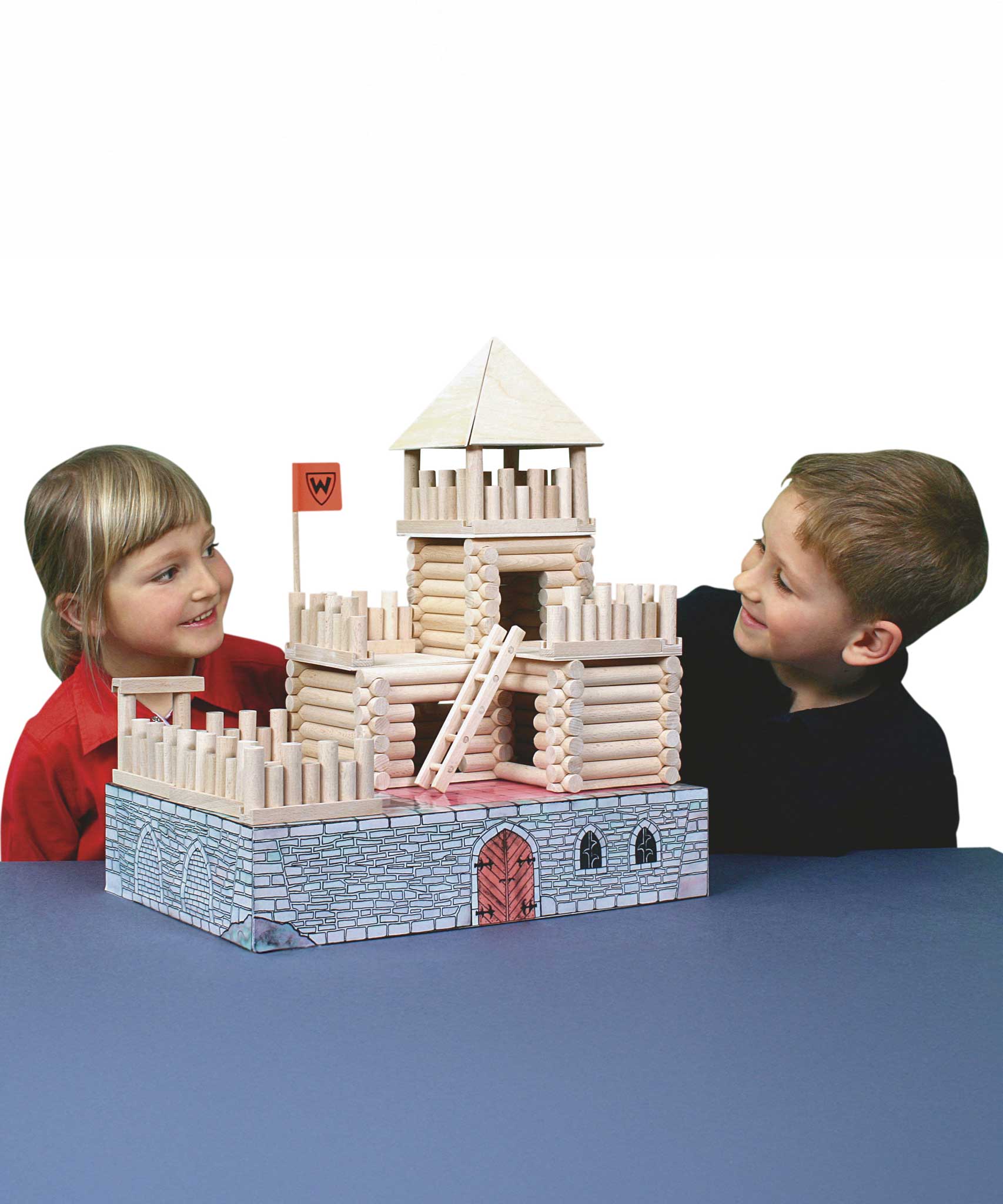 Two children looking at the fort build created using the Walachia Vario Fort Building Set 194 Pieces. This modular wooden building block system is perfect for those who enjoy a challenge. The sets are available in various sizes at Babipur. 