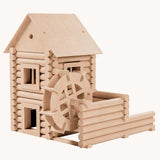 A water mill built using the Walachia Vario Mill Wooden Building Set 122 Pieces. This modular wooden building block system is perfect for those who enjoy a challenge. The sets are available in various sizes at Babipur.  